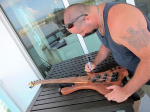 Eric Lee Beddingfield is signing the 2013 Charity Bass.